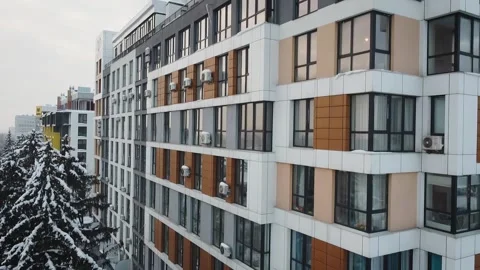 Aerial side view of a newly built modern high-rise apartment building facade Stock Footage 258679413