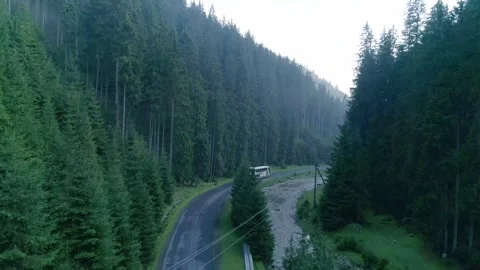 Aerial side view of a paved mountain road running parallel Stock Footage 330726571