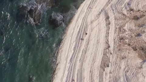 Aerial side view of Scala dei Turchi white cliffs rising from turquoise sea Stock Footage 330850650