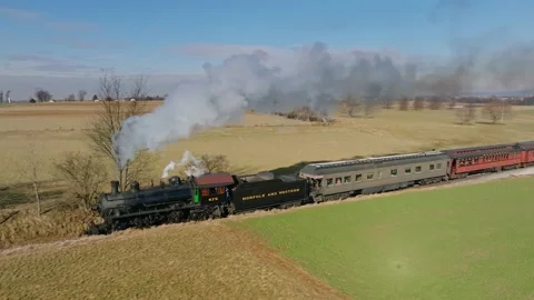 Aerial Side View in Slow Motion, of a Steam Passenger Train Approaching, Bl.. Stock Footage 235962386