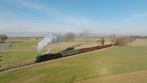 Aerial Side View in Slow Motion, of a Steam Passenger Train Approaching, Bl.. Stock Footage 235962661