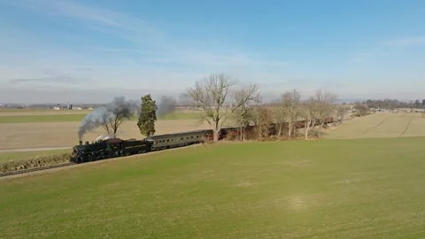 Aerial Side View in Slow Motion, of a Steam Passenger Train Approaching, Bl.. Stock Footage 238659714