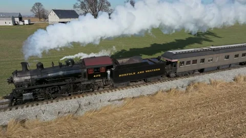 Aerial Side View of a Steam Passenger Train Traveling, in Slow Motion, Blow.. Stock Footage 238657909
