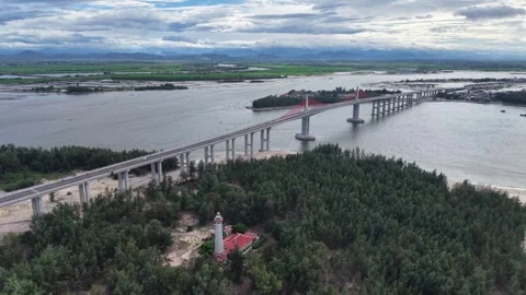 Aerial side view of Thuan An Bridge over wide lagoon 4K Stock Footage 339860524