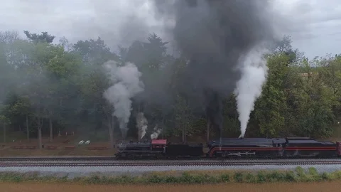 Aerial Side View of a Two Steam Locomotives Double Heading a Freight Train Stock Footage 124434787