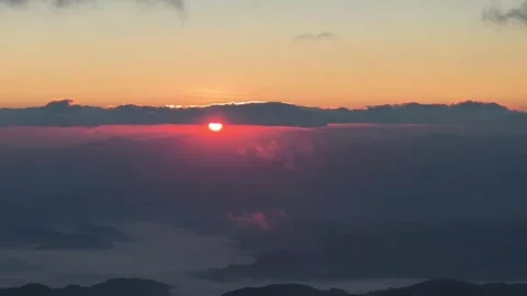 Aerial Sideways Flight Above Clouds During Sunrise Over Mountains Video stock 329339198