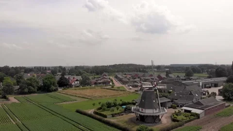 Aerial sideways panning showing typical Dutch windmill with wicks in Stock Footage 157464360