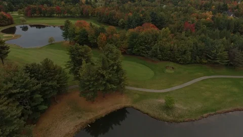 Aerial sight of nice golf course colored by various shades of trees in fall Stock Footage 117832683