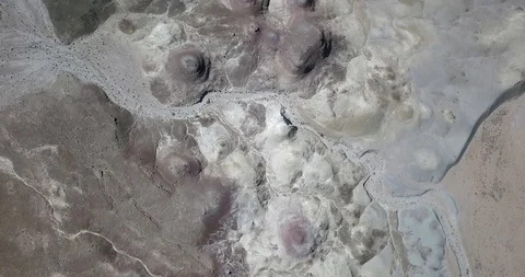 Aerial sinking toward alien landscape and pink colors of desert erosion Stock Footage 119088487