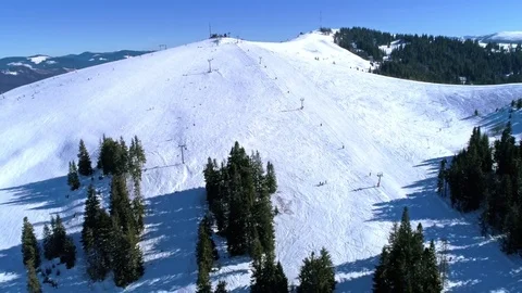 Aerial - Ski lift at ski resort in sunny Carpatian mountains Stock Footage