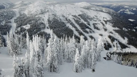Aerial of ski resort in mountains during winter season on sunny day, Canada Stock Footage 121587828