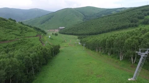 Aerial of ski resort in summer, alpine meadow Stock Footage 59552062