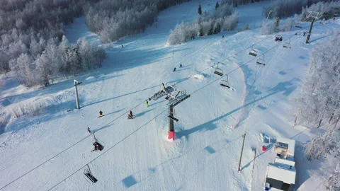 Aerial: ski resort on sunny day, people activity on mountain slope Stock Footage 149480341