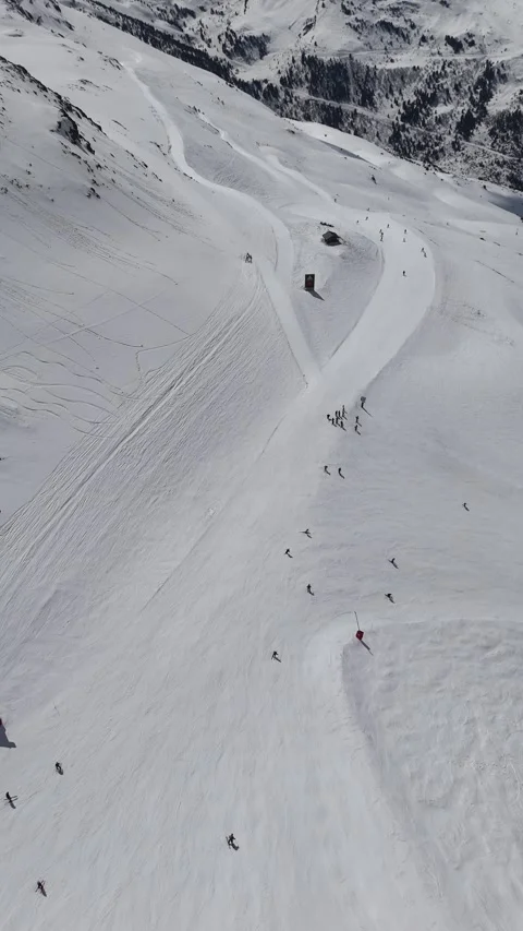 Aerial ski slopes of ski slopes in the mountains by winter Stock Footage 335887853