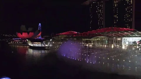 Aerial of skyscraper and light show at night in Singapore City Stock Footage 69142136