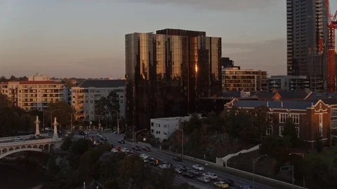 Aerial of skyscrapers, buildings and vehicles moving on street during sunset Stock-Footage 81001853