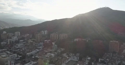 Aerial slides sideways as the sun sets behind the Monte de Tres Cruces Vídeos de archivo 78689968