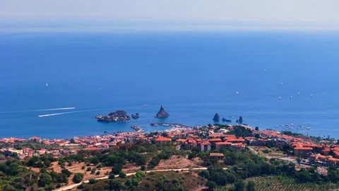 Aerial sliding view of Aci Trezza in Sicily and the Faraglioni Stock Footage 288205725