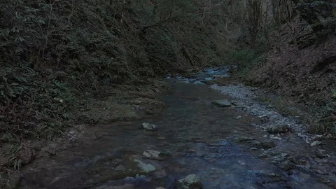 Aerial slow and smooth flight above mountain river as creek. Blue water Stock Footage 101708103
