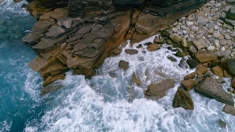 Aerial slow-mo of waves hitting rocky Atlantic coast at Cabo Carvoeiro, Portugal Stock Footage 93645434