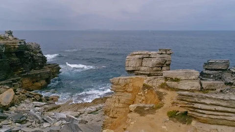Aerial slow-mo of waves hitting rocky Atlantic coast at Cabo Carvoeiro, Portugal Stock Footage 93645494