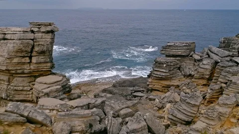 Aerial slow-mo of waves hitting rocky Atlantic coast at Cabo Carvoeiro, Portugal Stock Footage 93645656