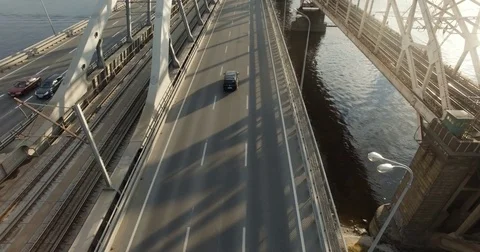 AERIAL, SLOW MOTION: Bridge overlooking wide heavy traffic speedway under Stock Footage 84967765