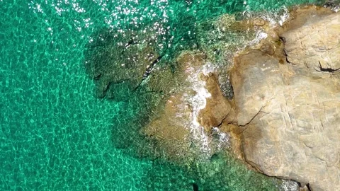 Aerial slow motion drone view of turquoise sea waves crushing into rocks Stock-Footage 278793025