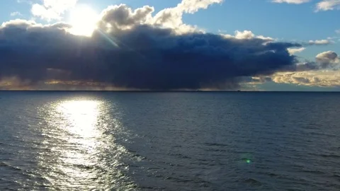 Aerial slow motion flight between the sea and the evening sky. Stock-Footage 82602776
