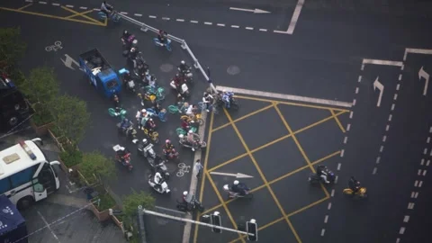 Aerial slow motion of intersection with traffic and yellow grid lines Stock Footage 317513307