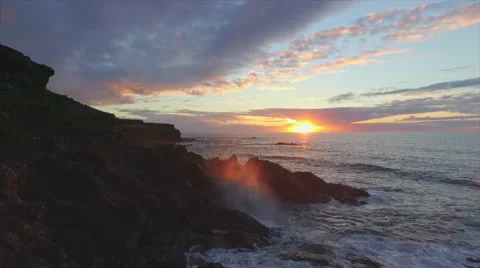 AERIAL SLOW MOTION: Ocean waves hitting rocky shore at sunset Stock Footage 52211859