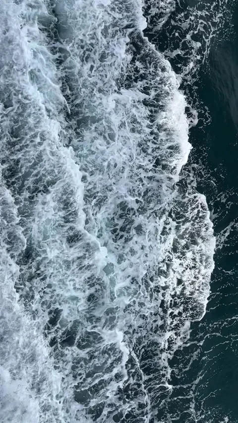Aerial Slow Motion Ocean Waves with White Sea Foam on Dark Blue Water, Vertical Stock Footage 334369916