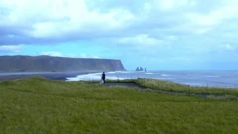 Aerial slow motion panoramic view of two newlyweds stand on the edge of a cliff 스톡 동영상 167118451