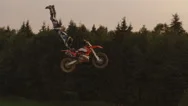 Aerial Slow Motion: Pro Motocross Biker Performing Superman Trick Over Sun Stock Footage
