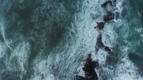 Aerial Slow Motion Shot Of Waves Rushing Towards Rocky Shore Stock Footage 79646978