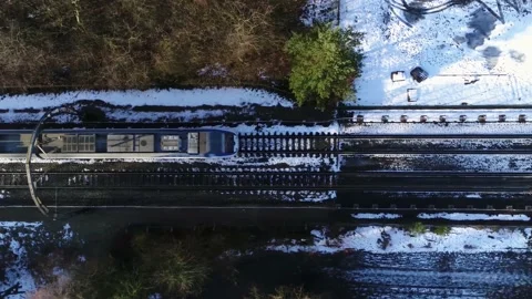 Aerial slow motion top down view of train arriving at railway station 4k Stock Footage 150269866