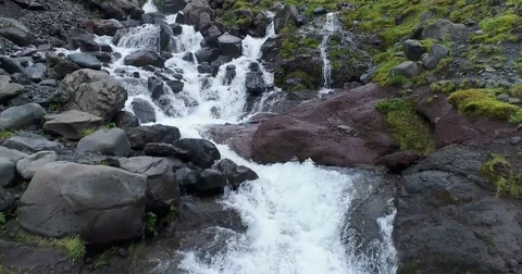 Aerial slow motion view of cascading river stream over rocks Видео 79857979