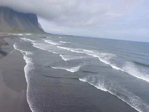 Aerial slow motion view of ocean waves - Stokksnes Iceland Видео 72325418