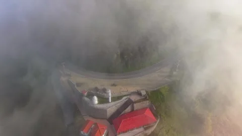 Aerial Slow Motion View of a Winding Road Covered in Coastal Fog 스톡 동영상 341751191