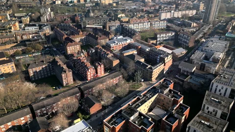 Aerial slow move forwards over London residential flats and apartments Stock Footage 238358019