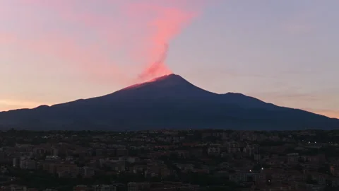 Aerial Slow Pan of Mount Etna Volcano Eruption with Pink Smoke Plume at Sunset Video stock 337777143