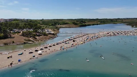 Aerial Slow Pan of Sandy Peninsula and Turquoise Sea in Nin Stock Footage 331729190