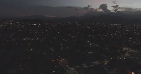 Aerial slowly pulling back over the town of Valledupar just after sunset Vídeos de archivo 77827040