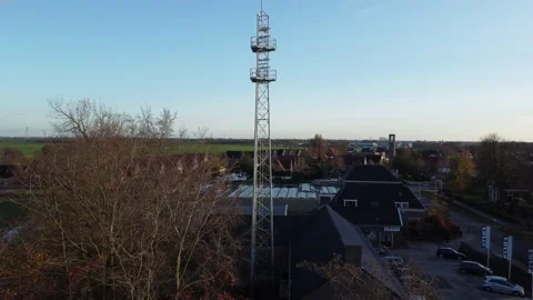 Aerial of a small cellphone tower in a small dutch village in autumn, 4K Stock Footage