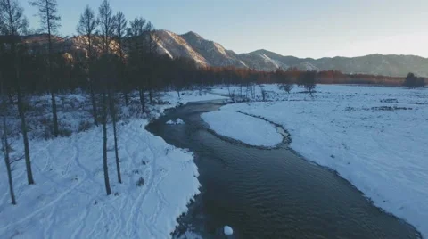 Aerial - Small clear river in the mountain valley in winter 4K Stock Footage 57352827