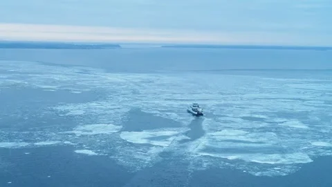 Aerial of small ferry sailing through icy water in Denmark Video stock 287914971