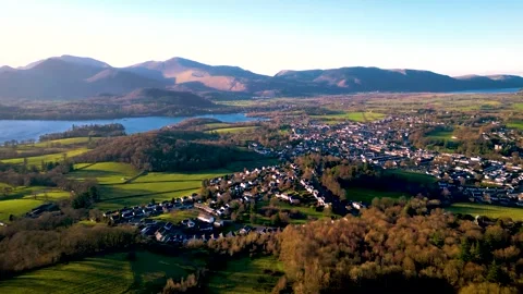 Aerial of small mountain town at sunset - Keswick, Cumbria Stock Footage 325681067