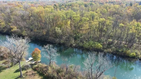 Aerial of a small river surrounded by trees Stock Footage 291323801