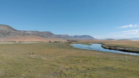 Aerial-Small stream swollen by spring runoff escapes its banks Stock-Footage 112361183