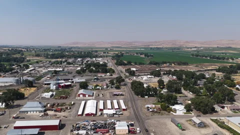 Aerial of small town industrial complex and agricultural fields in Vale Oregon Video stock 341303276
